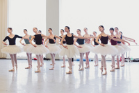 A photo of the female dancers in the corps de ballet in rehearsal in a ballet studio