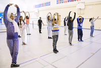 Photo of children in a movement workshop in a school gymnasium
